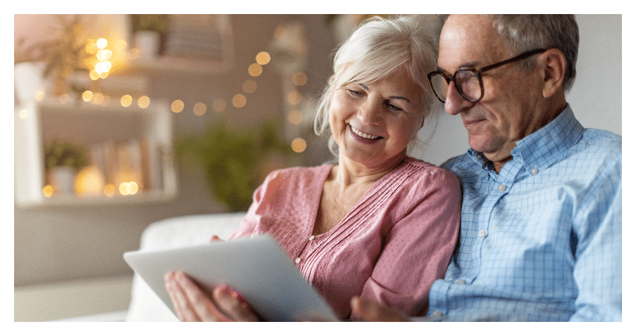 Happy mature couple researching hearing services in Maine
