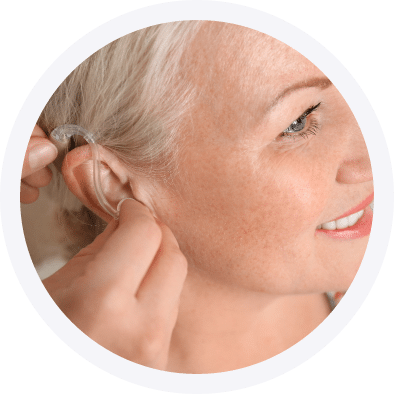 Woman getting her hearing aids fitted by an audiologist